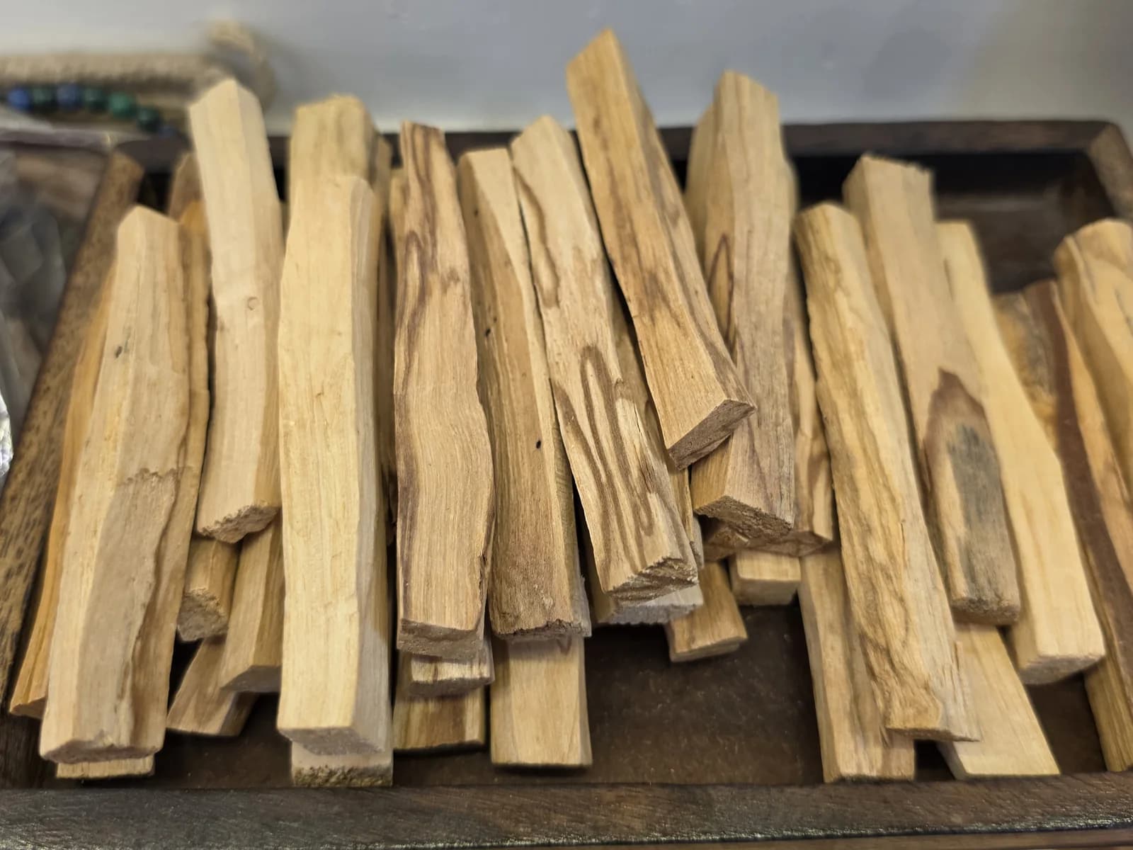 A tray of palo santo sticks in the Sacred Divine studio