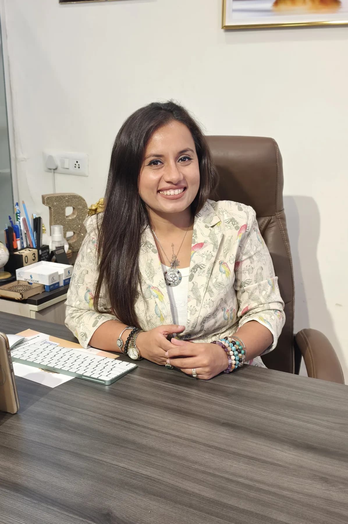 Bhaarti Sunny Ghai at her desk in the Sacred Divine studio